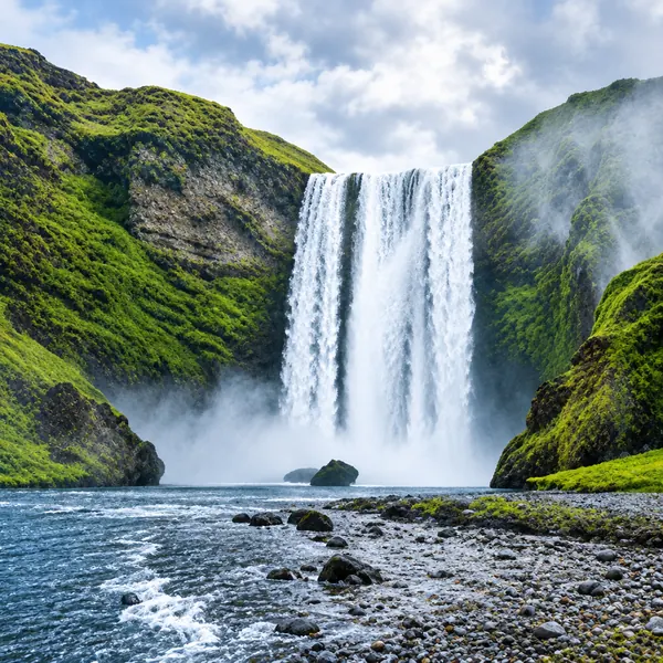 Waterfall plunging over a mossy cliff in Iceland